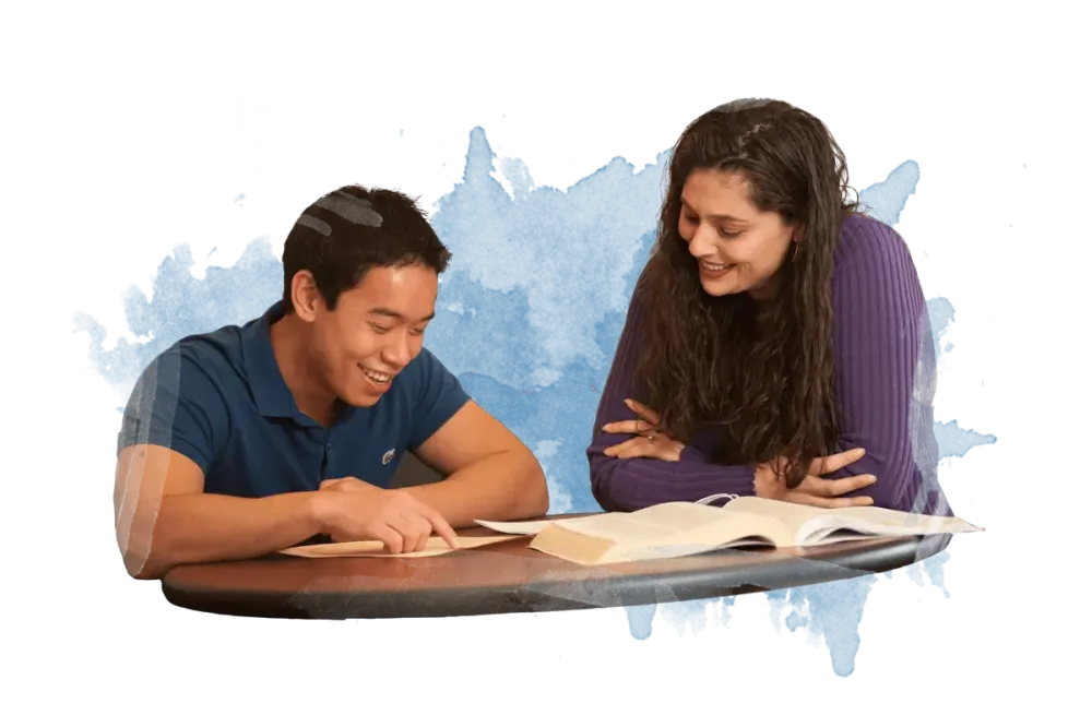 Two people discussing studies while looking at notes